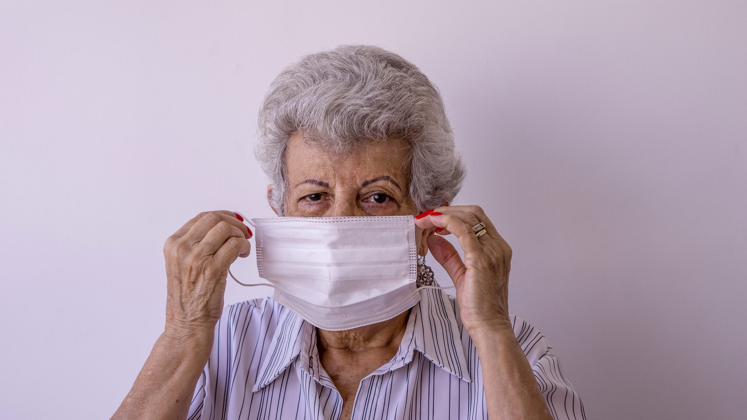 Elderly woman wearing protective mask against corona virus